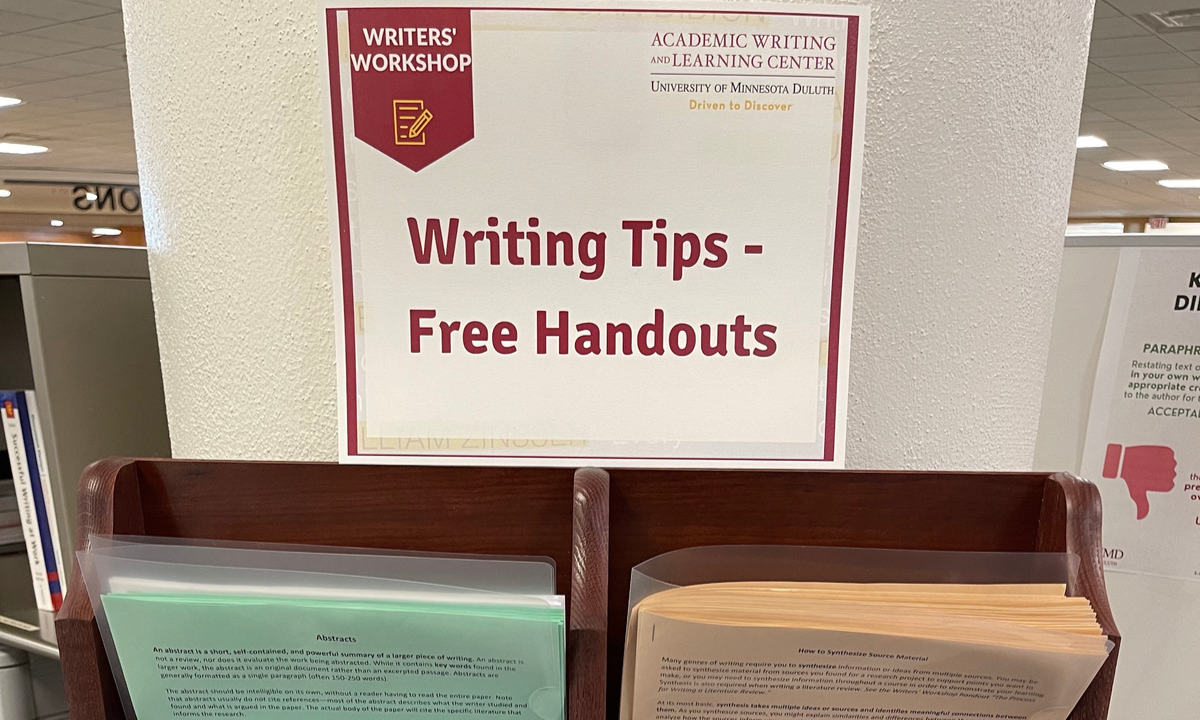 a sign advertising "free handouts" is hung above a rack full of papers and handouts